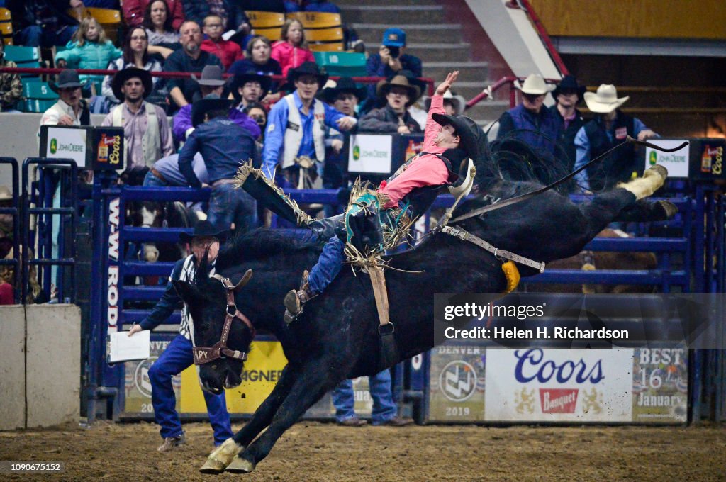 Cadogan Rodeo Clint Laye, of Cadogan, Alberta, hangs on to his horse as he competes ...