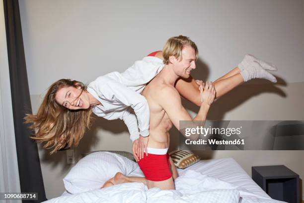 couple having fun in bed - couple playful bedroom stock-fotos und bilder