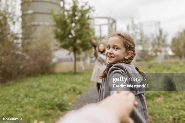 portrait of smiling girl holding hands outdoors - personal perspective or pov stockfoto's en -beelden