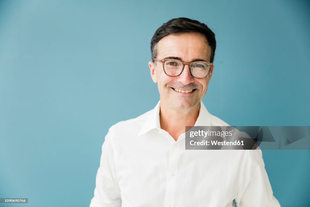 Portrait of smiling businessman wearing glasses