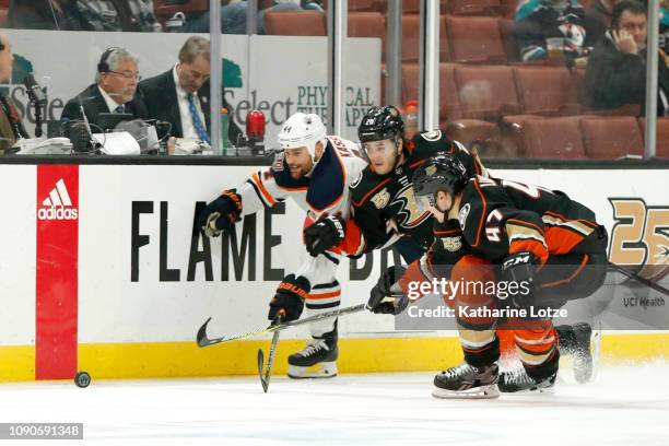 Zack Kassian of the Edmonton Oilers, Pontus Aberg of the Anaheim Ducks, and Hampus Lindholm of the Anaheim Ducks go after the puck during the second...