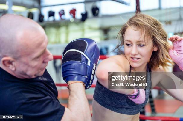 female martial artist sparring with coach - learning agility stock pictures, royalty-free photos & images