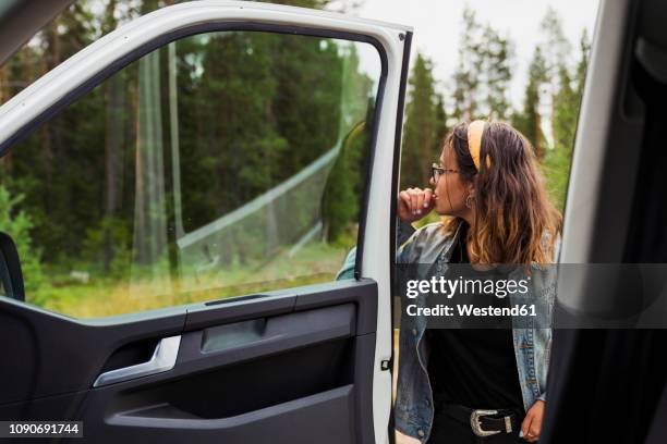 finland, lapland, young woman at a car in rural landscape - vehicle door stock pictures, royalty-free photos & images