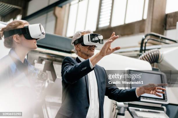 businessman and skilled worker in high tech enterprise, using vr glasses - vr glasses imagens e fotografias de stock