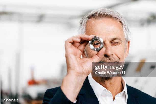 manager in high tech enterprise, checking machine parts - persistência imagens e fotografias de stock