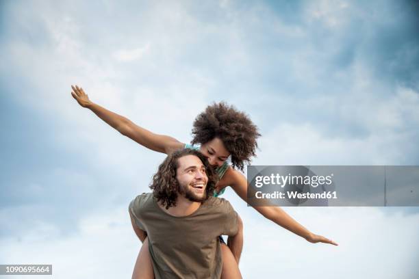 happy carefree couple outdoors - couple outdoors imagens e fotografias de stock