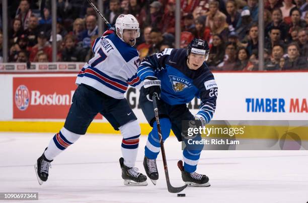 Santeri Virtanen of Finland skates past Evan Barratt of the United States in Gold Medal hockey action of the 2019 IIHF World Junior Championship...