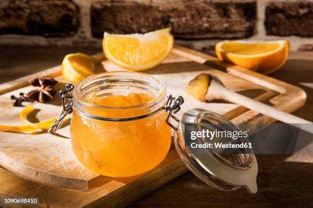 preserving jar of homemade orange marmalade - marmellata di agrumi foto e immagini stock
