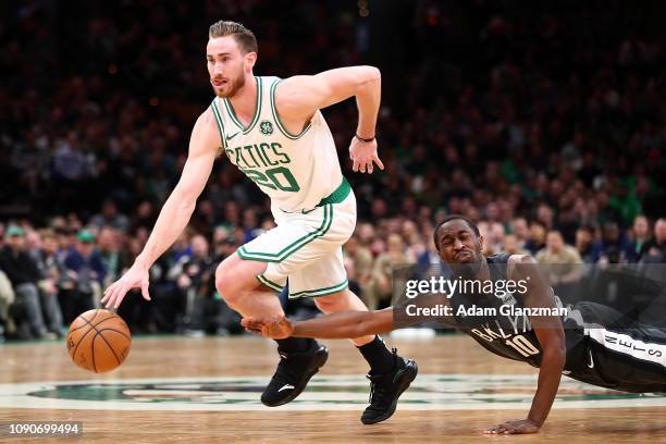 Gordon Hayward of the Boston Celtics dribbles the ball as Theo Pinson of the Brooklyn Nets lunges during a game at TD Garden on January 28, 2019 in...