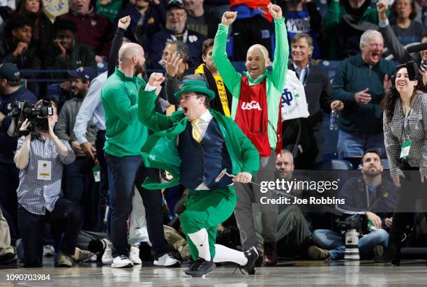The Notre Dame Fighting Irish leprechaun mascot reacts after rolling in a 90-foot putt during a timeout promotion for the 2019 U.S. Senior Open in...