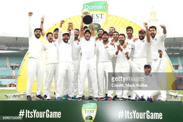 India celebrate with the trophy after a 2-1 series win after day five of the Fourth Test match in the series between Australia and India at Sydney...