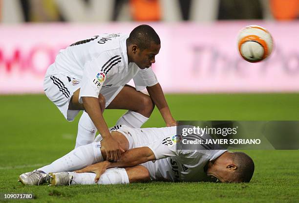 Real Madrid's Brazilian Robinho looks to help injured teammate Ronaldo during their Spanish league football match against Atletico de Madrid at the...