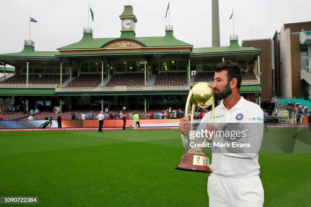 Player of the series, Cheteshwar Pujara of India holds up the Border–Gavaskar Trophy as he celebrates India's 2-1 series win after day five of the...