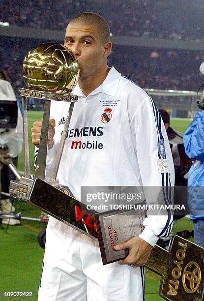 Spanish club team Real Madrid foward Ronaldo of Brazil kisses the Inter-Continental cup after winning over South American champion Olympia of...