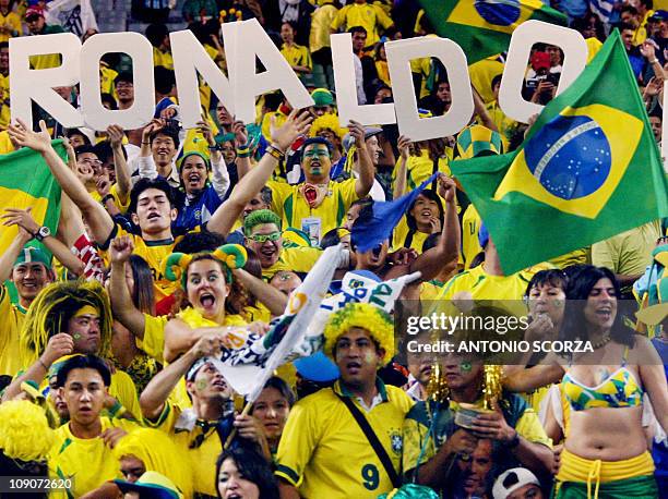 Brazilian fans hoist the name of No. 9, Brazil's forward Ronaldo, after he scored the winning goal against Turkey in match 62 of the 2002 FIFA World...