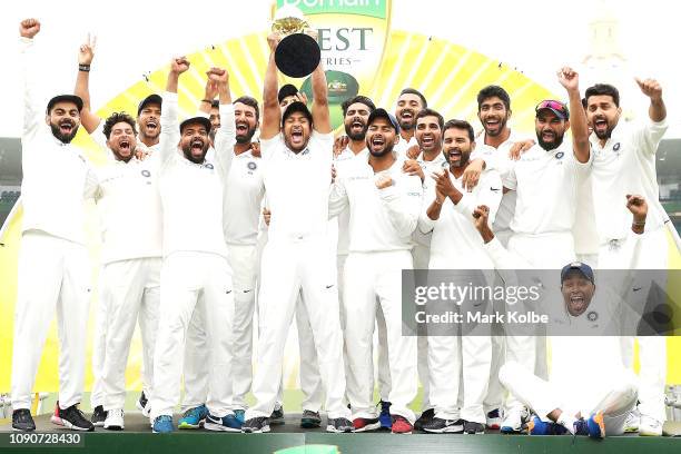 India celebrate with the trophy after a 2-1 series win after day five of the Fourth Test match in the series between Australia and India at Sydney...