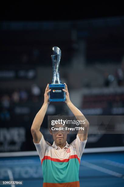 Kei Nishikori of Japan poses with the trophy after defeating Daniil Medvedev of Russia during day eight of the 2019 Brisbane International at Pat...