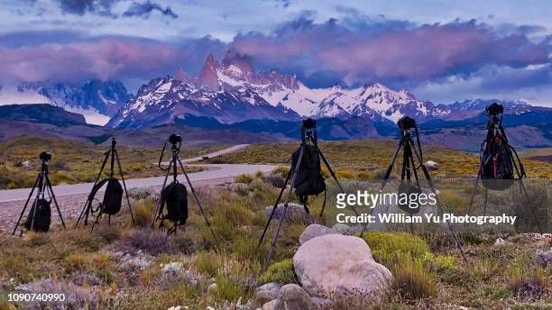 cameras and tripods set to photograph snowcapped mt. fitzroy, patagonia - camera bag stock-fotos und bilder
