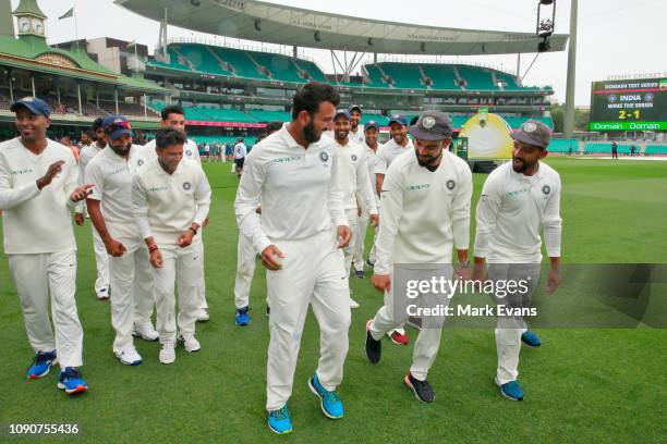 Cheteshwar Pujara, Virat Kohli and Ajinkya Rahane of India dance as they celebrate winning the Border Gavaskar trophy during day five of the fourth...