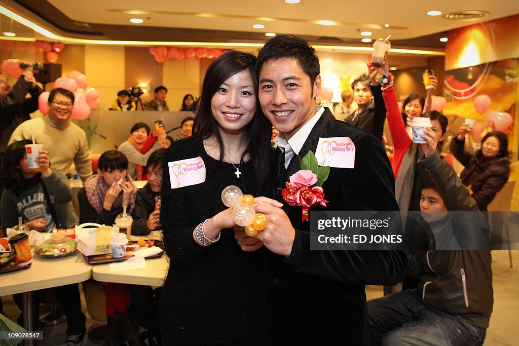 Kelvin Kwong (R) and Ashley Tse pose for