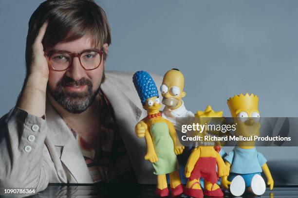 American Cartoonist Matt Groening poses with characters from his animated TV series "The Simpsons", November 1990.
