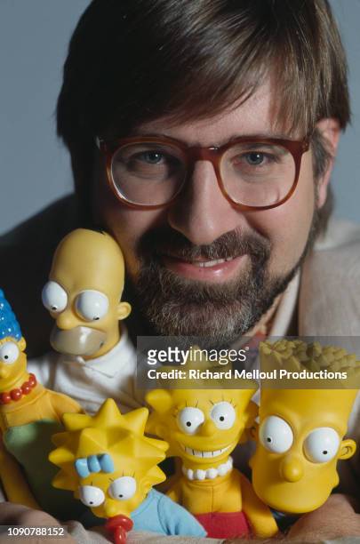 American Cartoonist Matt Groening poses with characters from his animated TV series "The Simpsons", November 1990.