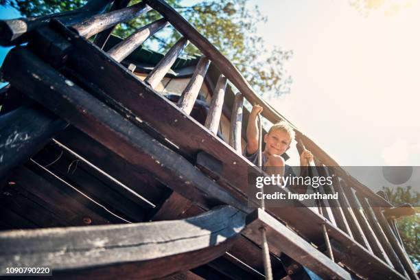 little boy playing in a tree house - kids fort stock pictures, royalty-free photos & images