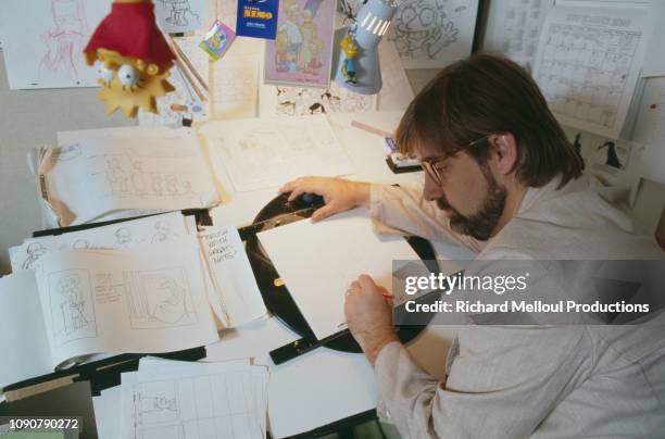American Cartoonist Matt Groening poses with characters from his animated TV series "The Simpsons", November 1990.