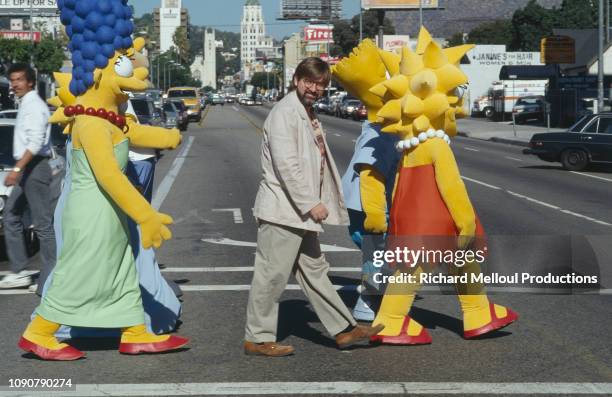 American Cartoonist Matt Groening poses with characters from his animated TV series "The Simpsons", November 1990.