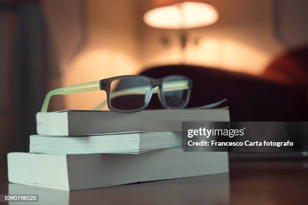 evening reading - reading glasses imagens e fotografias de stock