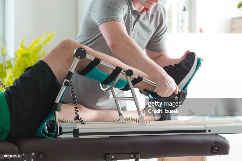 Man's knee rehabilitation in medical center