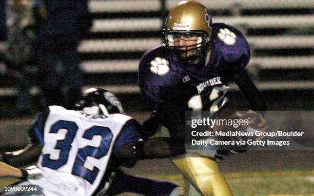 Boulder quarterback Taylor Henry avoids the sack from Grandview's Jeff Craig.