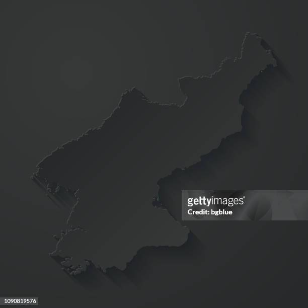 nordkorea-karte mit papier schneiden effekt auf schwarzem hintergrund - north korea stock-grafiken, -clipart, -cartoons und -symbole