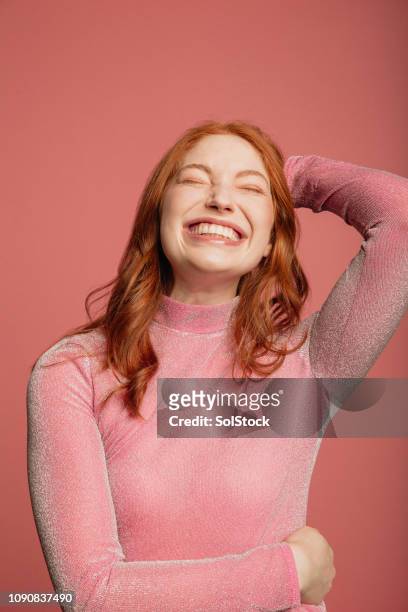 headshot of a smiling redhead - pretty in pink imagens e fotografias de stock