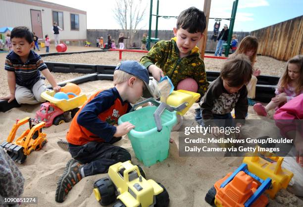 Liam Sweeney, left center, and Max Hagen, right center, both 4, play in the sandbox at the Montessori Academy in Lafayette on Monday. The school is...
