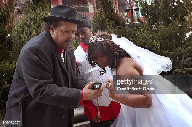 James Latham and his new bride Pamela Lee pose choose a picture to be printed by photographer William Riley outside Cook County's Marriage Court...