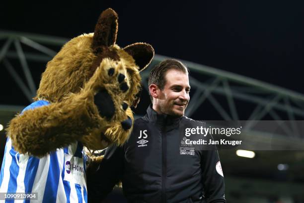 Jan Siewert, Manager of Huddersfield Town speaks to the mascot prior to the Premier League match between Huddersfield Town and Everton at John...