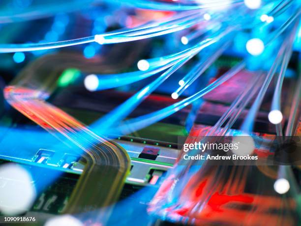 fibre optic strands carrying data over electronic circuit board of laptop computer - 通信設備 ストックフォトと画像