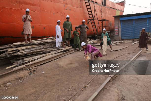 Madrasa students play cricket at a Shipyard in Dhaka, Bangladesh on January 29, 2019.