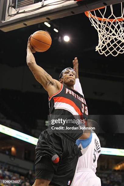 Dante Cunningham of the Portland Trail Blazers dunks against Martell Webster of the Minnesota Timberwolves during the game on February 14, 2011 at...