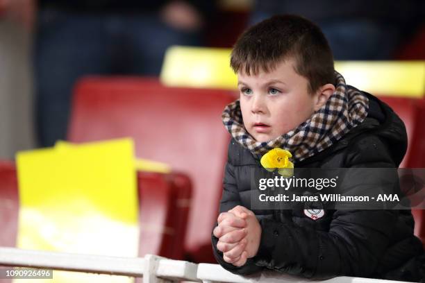 Young Cardiff City fan wearing a Daffodil in support of missing Cardiff City player Emiliano Sala during the Premier League match between Arsenal FC...