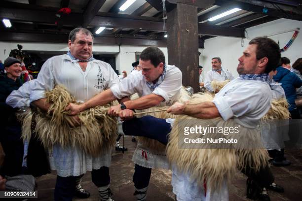 &quot;The joaldunak&quot; or cowbell carriers, need the help of their peers to tighten their bells well, to go out at the carnival in Zubieta On...