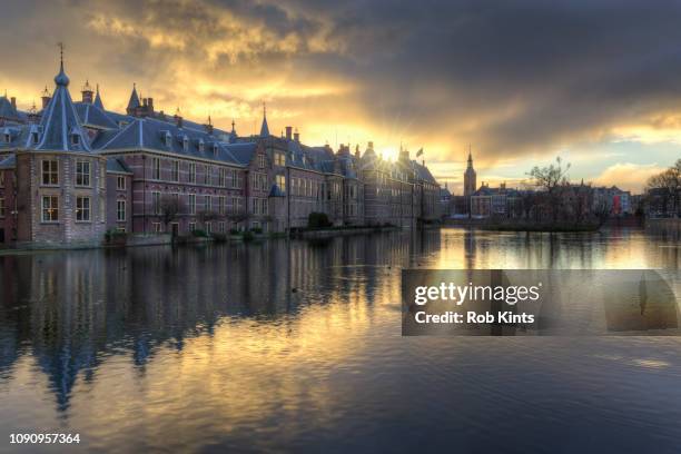 dark clouds over dutch houses of parliament (binnenhof) at sunset - courtyard stock pictures, royalty-free photos & images