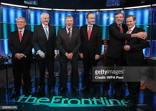 Broadcaster Pat Kenny laughs as Sinn Fein's Gerry Adams hugs Enda Kenny of Fine Gael as Eamon Gilmore of Labour , John Gormley of the Green Party and...