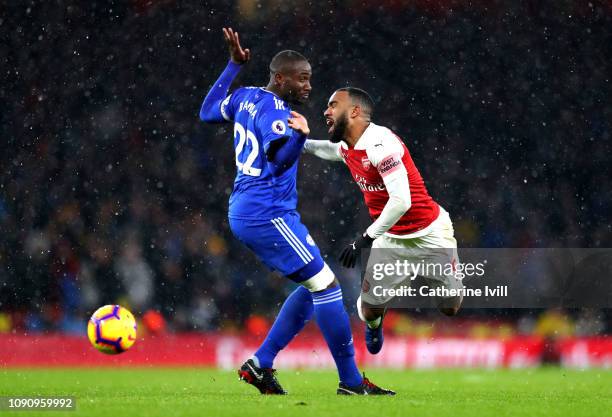 Sol Bamba of Cardiff City collies with Alexandre Lacazette of Arsenal during the Premier League match between Arsenal and Cardiff City at Emirates...