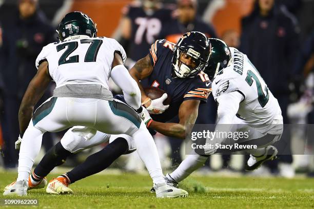 Allen Robinson of the Chicago Bears is brought down by Corey Graham and Malcolm Jenkins of the Philadelphia Eagles during the NFC Wild Card Playoff...