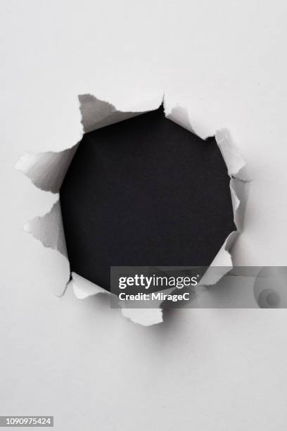 circle shape paper hole - torn reveal textured paper stock pictures, royalty-free photos & images