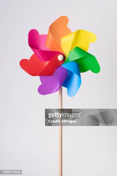 rainbow colored pinwheel toy - the whirligig stockfoto's en -beelden