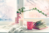 Valentine's day background,mug on window still.Comfort winter life style.