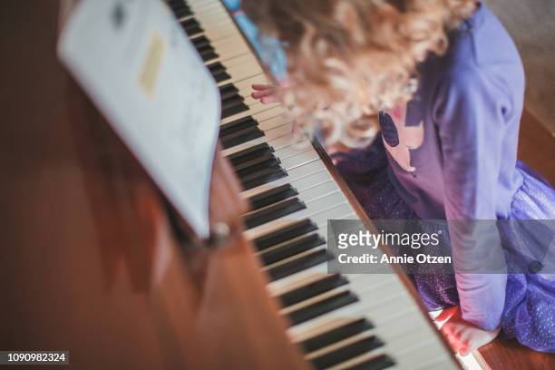 girl playing piano - practicing piano stock pictures, royalty-free photos & images
